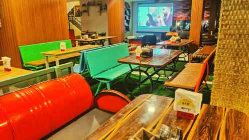 a restaurant with tables and chairs in a room at Rajdhani Resort Lonavala in Lonavala