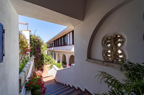 a building with stairs leading up to a building with flowers at Casa Azzurra in Messina