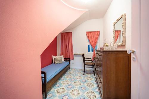 a bedroom with a bed and a dresser and a mirror at Casa Azzurra in Messina