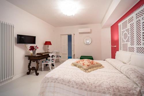 a bedroom with a bed and a desk with a computer at Casa Azzurra in Messina