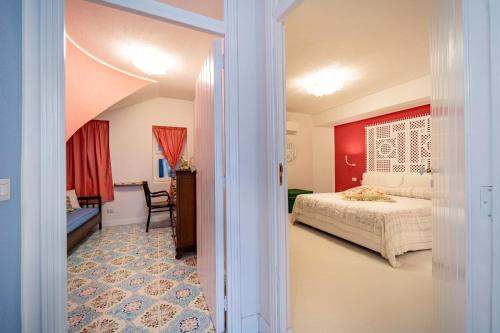 a bedroom with a bed and a chair in a room at Casa Azzurra in Messina