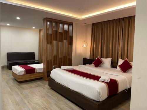 a hotel room with two beds and a desk at THE IMPERIAL HOTEL & Spa in Gangtok