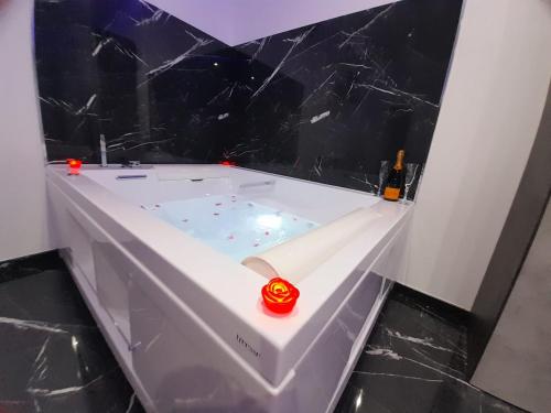 a white bath tub with a red candle in it at Casa Birmano in Taranto