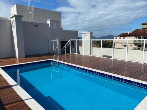 a swimming pool on the roof of a house at Ubatuba in Ubatuba