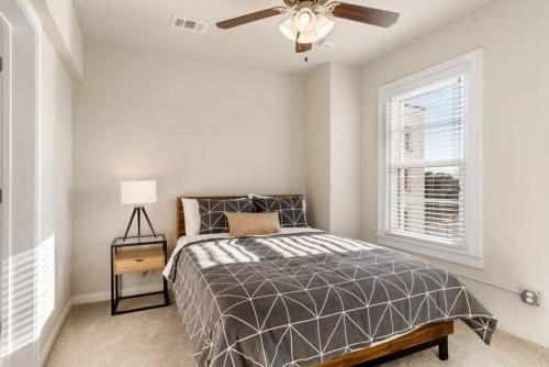 a bedroom with a bed and a ceiling fan at Chic Downtown Waco Apartment in Waco