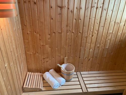 a sauna with two towels and a cup of coffee at Moin Mehrblick in Schillig
