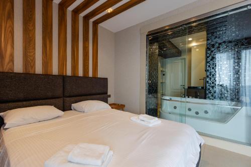 a bedroom with a bed with two towels on it at The SPOT apartments - Orbi Beach Tower in Batumi
