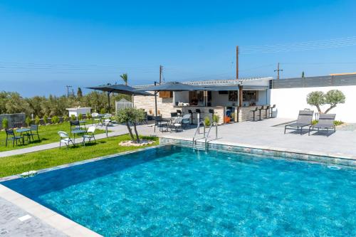 a swimming pool in front of a house at Antesia Coral Bay Resort by Ezoria Villas - Adults only in Coral Bay