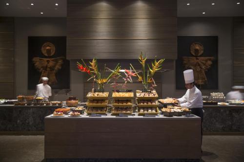 a chef standing in front of a buffet of food at NIZUC Resort & Spa in Cancún