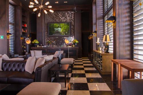 a restaurant with couches and tables in a room at NIZUC Resort & Spa in Cancún