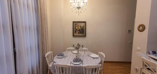a dining room with a table with chairs and a chandelier at Cozy LUXURY apartments*****. The city center in Valencia