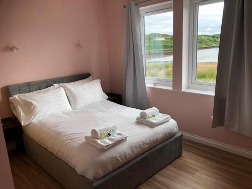 a bedroom with a bed with two towels on it at Loch Caroy Bay Cottage in Ose