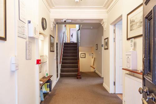 a hallway with a staircase in a building at City Centre Guest House - Gloucester Park in Gloucester