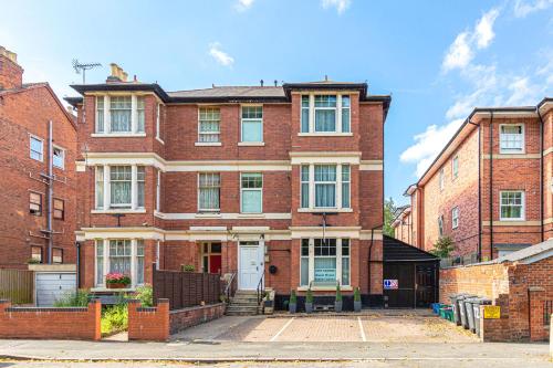 a red brick house with a white door at City Centre Guest House - Gloucester Park in Gloucester