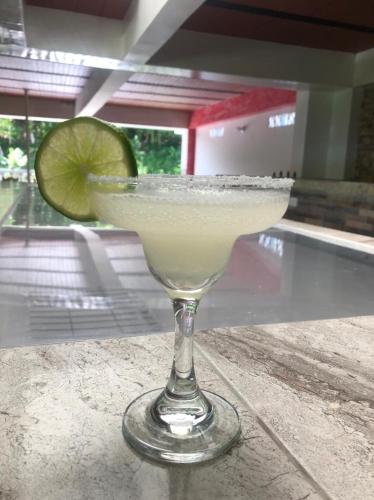 a margarita in a glass with a lime at Hotel Jireh - San Carlos Ant in San Carlos