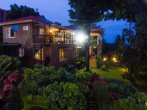 a house with a light on the side of it at Ewange - A Casa Mia in Kampala