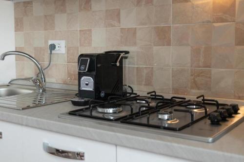 a toaster sitting on top of a stove in a kitchen at intero appartamento poseidon 46 mq in Fasano