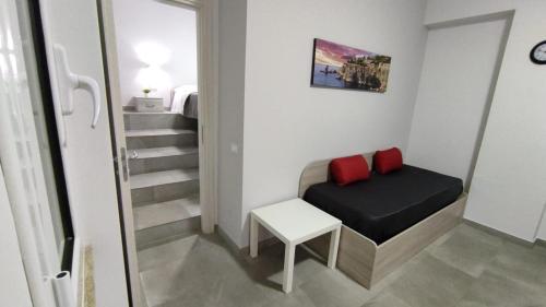 a small room with a bed and a stair case at Case Vacanze Blue Sea in Mascali