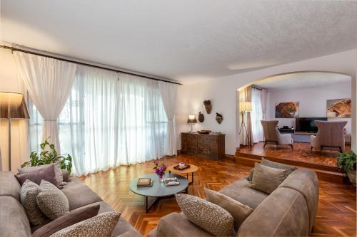 a living room with a couch and a table at Ewange - A Casa Mia in Kampala