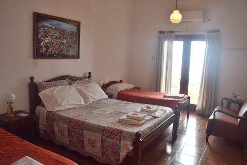 a bedroom with a bed and a table and a window at HOSTAL TILIAN in Salta