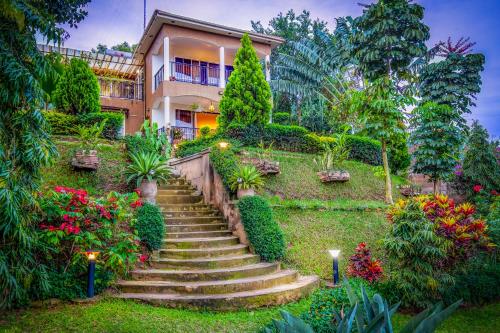 a staircase leading to a house with flowers and plants at Ewange - A Casa Mia in Kampala