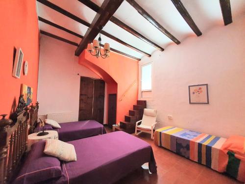 a room with two beds and a couch at CASA BAUTISTA TURIS in Turís