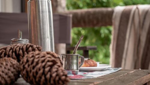 a table with a cup and a plate of food at Pampas del Sur Hotel y Spa de campo in Cañuelas