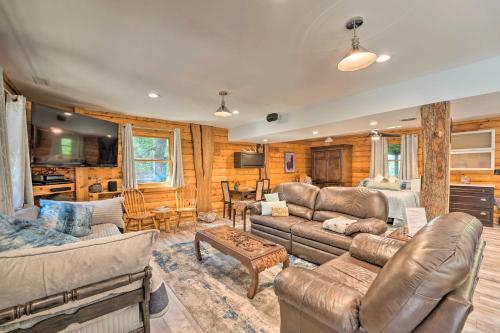 a living room with couches and a table at Cozy Wisconsin Studio, 11 Mi to Lake Geneva! in Burlington
