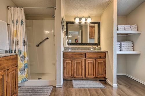 a bathroom with a sink and a mirror and a shower at Family-Friendly San Marcos Home Close to TSU! in San Marcos