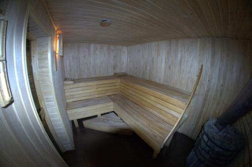 a large wooden sauna with a bench in it at Prutets Guest House in Tatariv