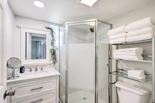 a white bathroom with a shower and a sink at 11 Mi to Great Salt Lake Magna Getaway! in West Valley City
