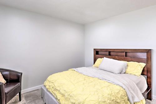 a bedroom with a bed with yellow sheets and a chair at 11 Mi to Great Salt Lake Magna Getaway! in West Valley City