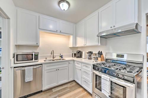 a kitchen with white cabinets and stainless steel appliances at Updated Poway Farmhouse Walk to Parks! in Poway