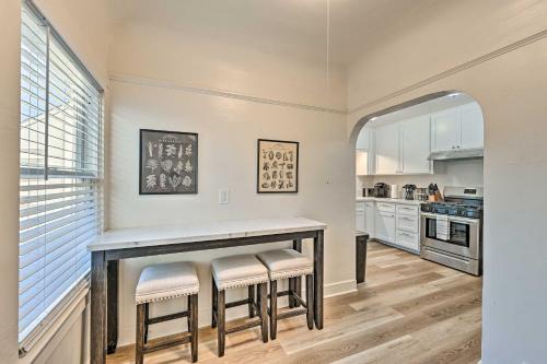 a kitchen with a table and stools at Updated Poway Farmhouse Walk to Parks! in Poway