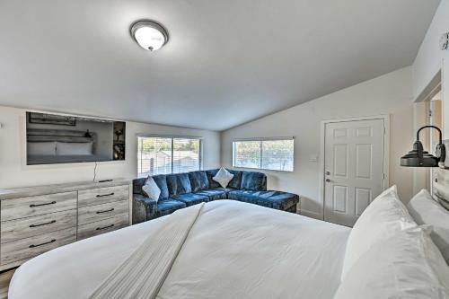 a bedroom with a large bed and a couch at Updated Poway Farmhouse Walk to Parks! in Poway