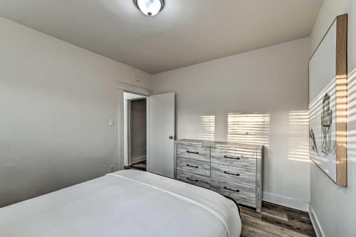 a bedroom with a white bed and a dresser at Updated Poway Farmhouse Walk to Parks! in Poway