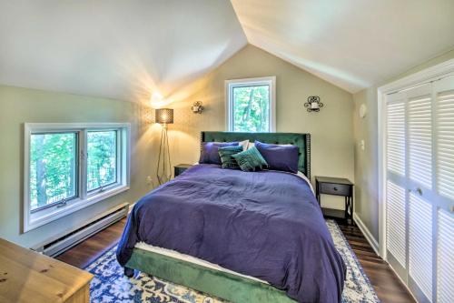 a bedroom with a bed with purple sheets and windows at Peaceful Nashville Hideaway Near State Parks! in Nashville