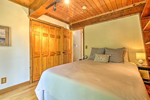 a bedroom with a large bed with wooden ceilings at Walk to Tuttle Creek Lake Secluded Scenic Retreat in Manhattan