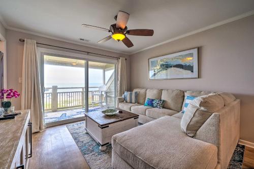 a living room with a couch and a ceiling fan at Beachfront Condo with Unobstructed Ocean Views! in Oak Island