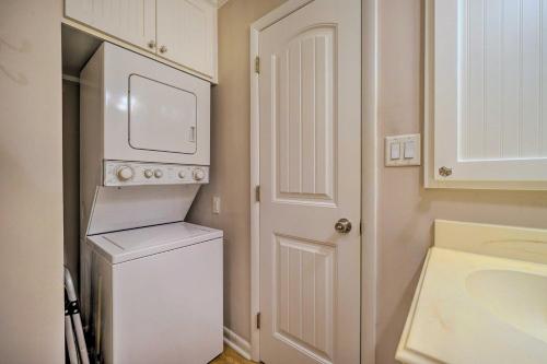 a white laundry room with a washer and dryer at Beachfront Condo with Unobstructed Ocean Views! in Oak Island