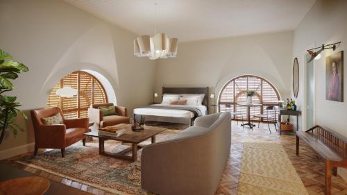 a bedroom with a bed and a table and chairs at The Quoin Hotel in Wilmington