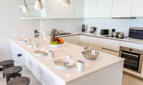 a kitchen with white cabinets and a white counter top at Tamarind Hills Resort & Villas in Johnsons Point