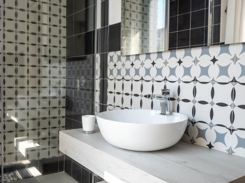 a bathroom with a white sink and a mirror at Affittacamere Solki in SantʼAntìoco
