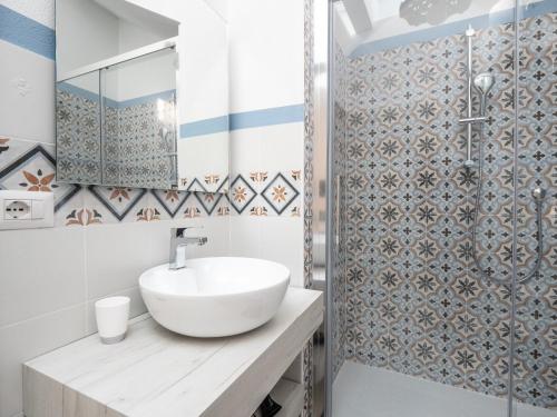 a bathroom with a sink and a shower at Affittacamere Solki in SantʼAntìoco