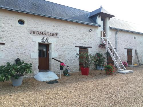 a white building with a sign on the side of it at Gîte de la Casse in Channay-sur-Lathan