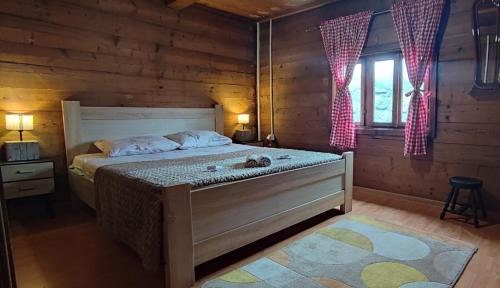 a bedroom with a bed in a log cabin at Vikendica Vlahović in Kolašin