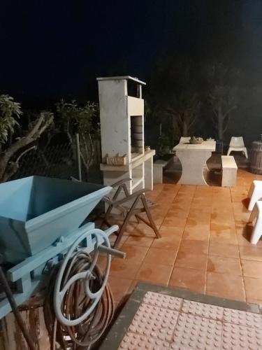 a patio with a blue cart on a wooden floor at casa da xusta in Picoña