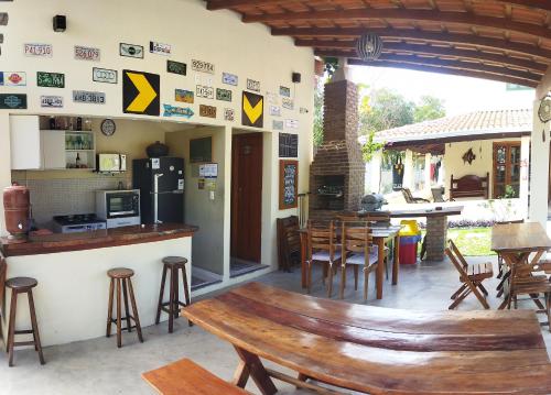 a bar with a wooden bench in a restaurant at Abrolhos Dive Inn in Caravellas
