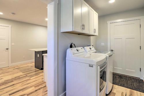 a laundry room with a white washer and dryer at Sun-Dappled Retreat - Walk to Wickaboag Lake! in West Brookfield