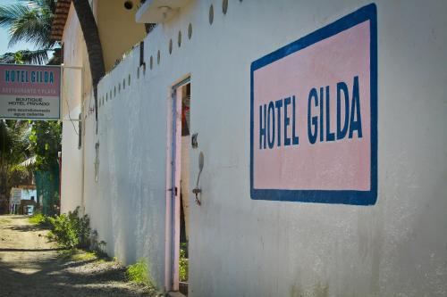 a sign on the side of a building at Hotel Gilda in Coyuca